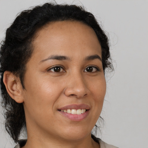 Joyful latino young-adult female with medium  brown hair and brown eyes