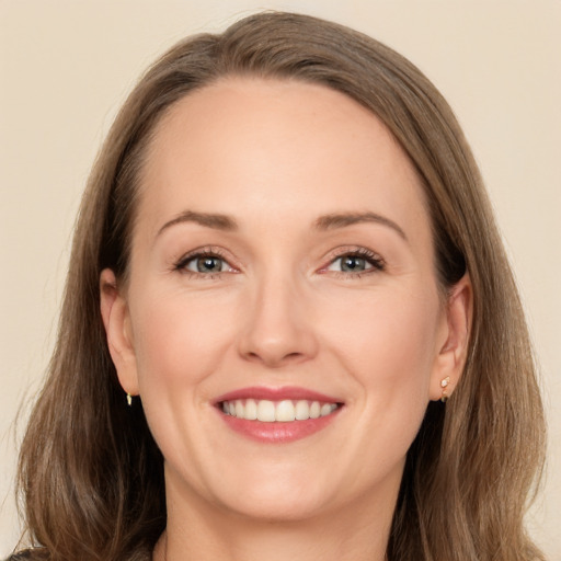 Joyful white adult female with long  brown hair and brown eyes