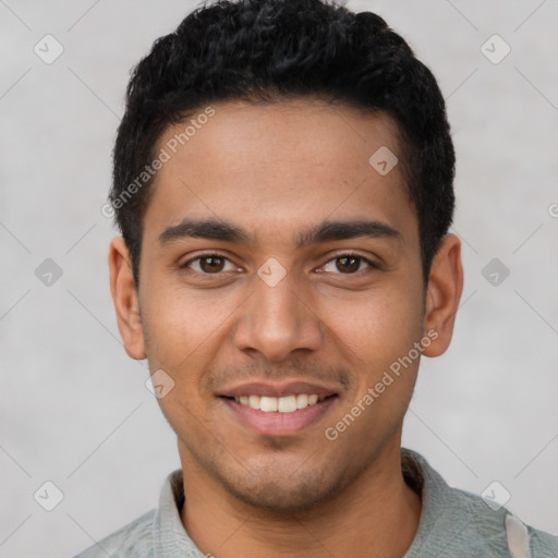 Joyful latino young-adult male with short  black hair and brown eyes