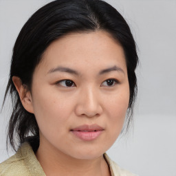 Joyful asian young-adult female with medium  black hair and brown eyes