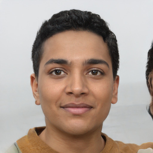 Joyful latino young-adult male with short  black hair and brown eyes
