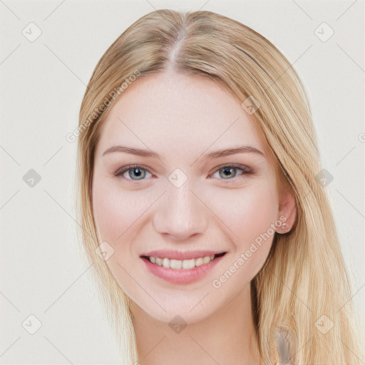 Joyful white young-adult female with long  brown hair and blue eyes