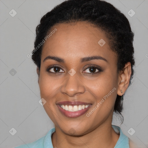 Joyful black young-adult female with medium  black hair and brown eyes