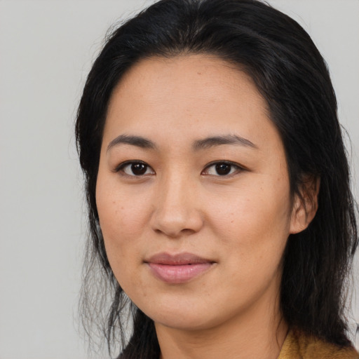 Joyful asian young-adult female with long  brown hair and brown eyes
