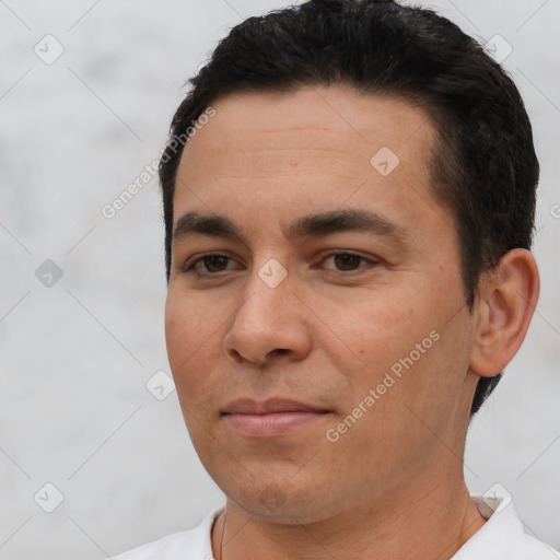 Joyful white young-adult male with short  black hair and brown eyes