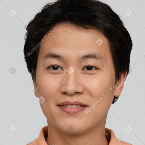 Joyful asian young-adult male with short  brown hair and brown eyes