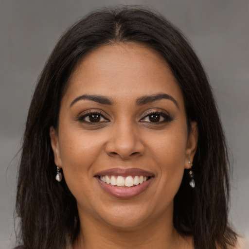 Joyful latino young-adult female with long  brown hair and brown eyes