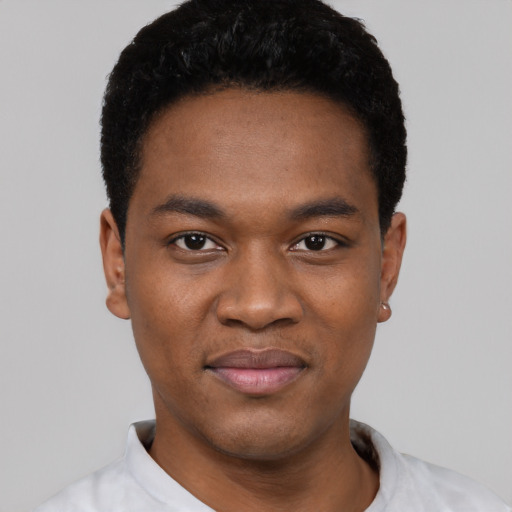 Joyful black young-adult male with short  black hair and brown eyes