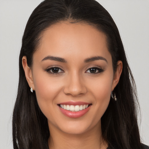 Joyful latino young-adult female with long  brown hair and brown eyes