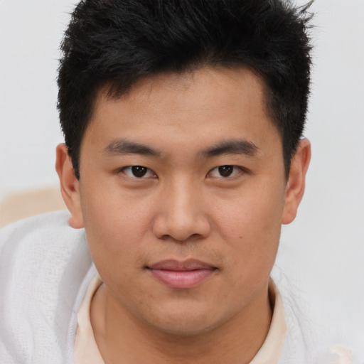 Joyful asian young-adult male with short  brown hair and brown eyes