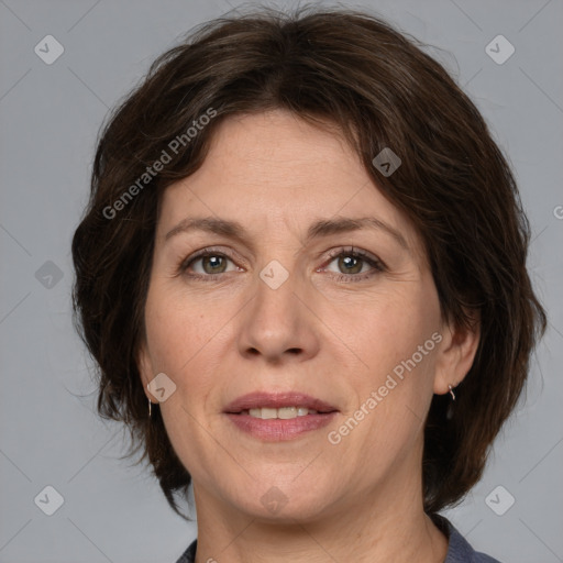 Joyful white adult female with medium  brown hair and grey eyes