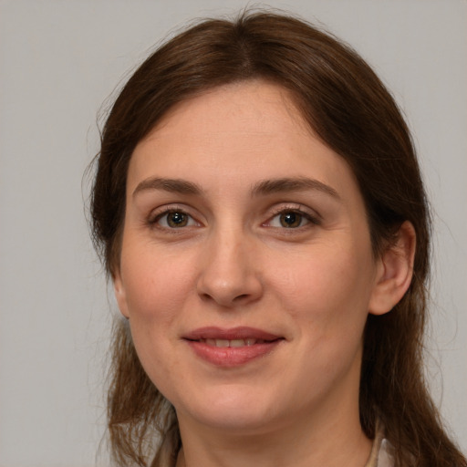 Joyful white young-adult female with long  brown hair and brown eyes