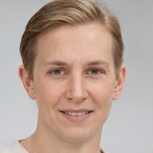 Joyful white adult female with short  brown hair and grey eyes