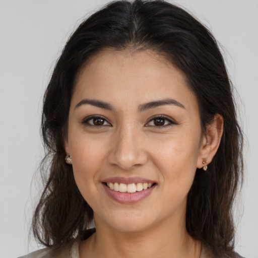 Joyful white young-adult female with long  brown hair and brown eyes