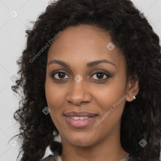 Joyful black young-adult female with long  brown hair and brown eyes