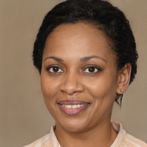 Joyful black young-adult female with short  brown hair and brown eyes