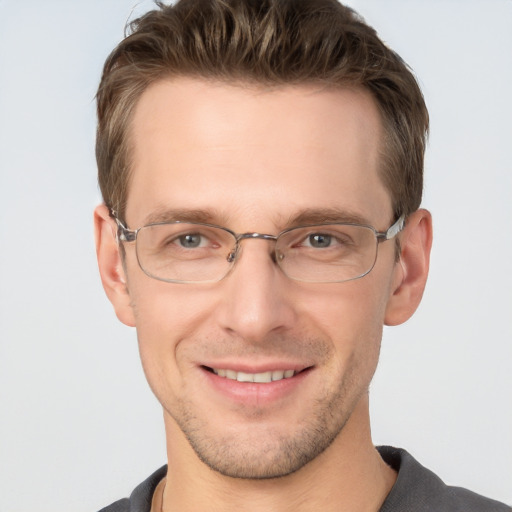 Joyful white adult male with short  brown hair and grey eyes