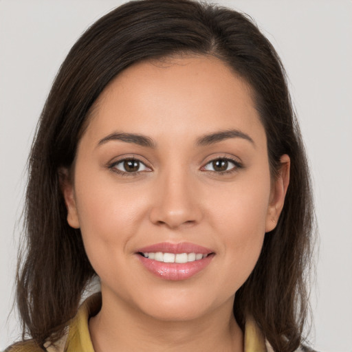 Joyful white young-adult female with long  brown hair and brown eyes