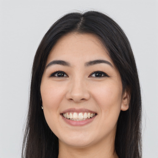 Joyful asian young-adult female with long  brown hair and brown eyes