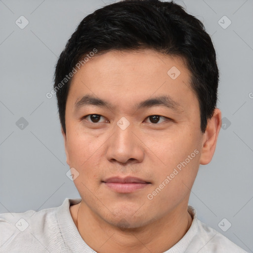 Joyful asian young-adult male with short  black hair and brown eyes