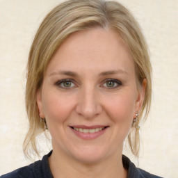 Joyful white adult female with medium  brown hair and blue eyes