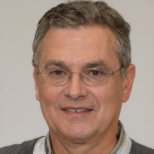 Joyful white middle-aged male with short  gray hair and brown eyes