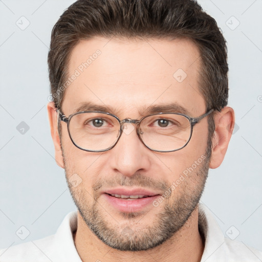 Joyful white adult male with short  brown hair and brown eyes