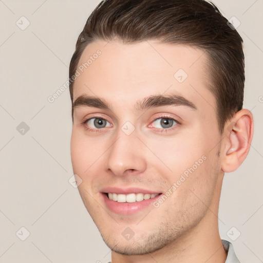 Joyful white young-adult male with short  brown hair and brown eyes