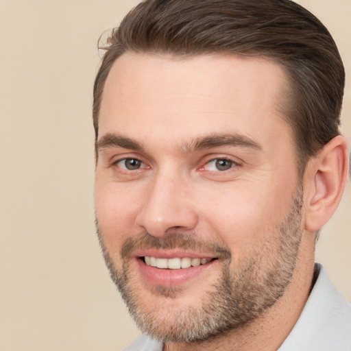 Joyful white young-adult male with short  brown hair and brown eyes