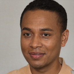 Joyful latino adult male with short  brown hair and brown eyes