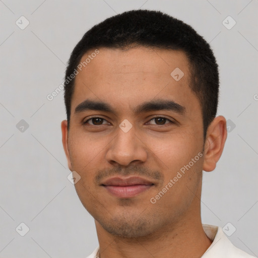 Joyful latino young-adult male with short  black hair and brown eyes