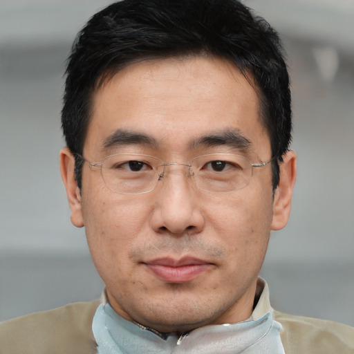 Joyful asian adult male with short  black hair and brown eyes