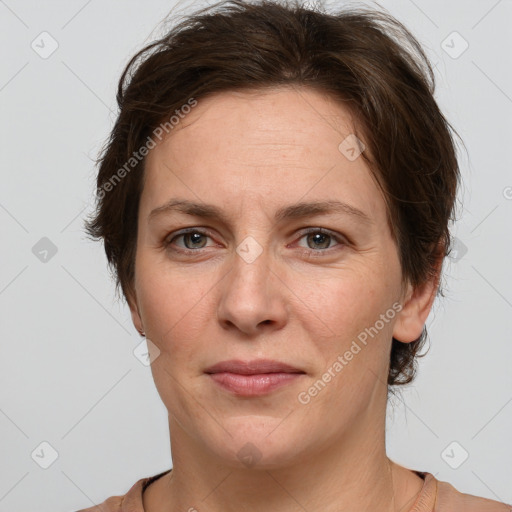 Joyful white adult female with short  brown hair and grey eyes