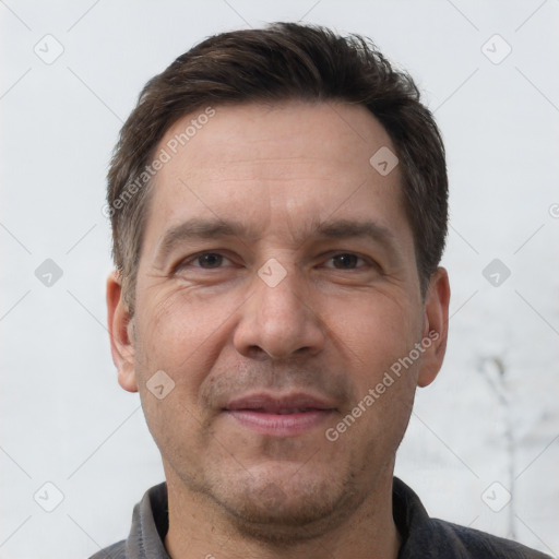 Joyful white adult male with short  brown hair and brown eyes