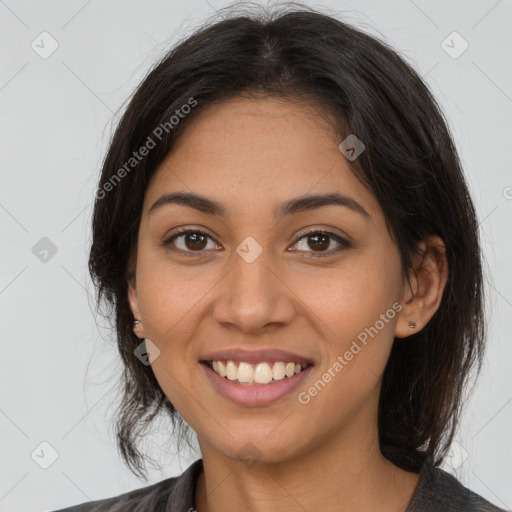 Joyful latino young-adult female with medium  brown hair and brown eyes