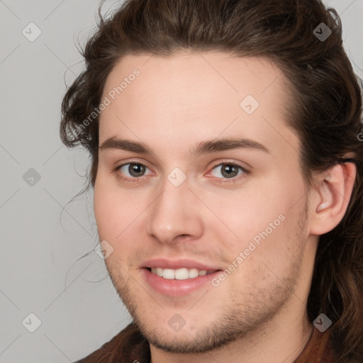 Joyful white young-adult male with medium  brown hair and brown eyes