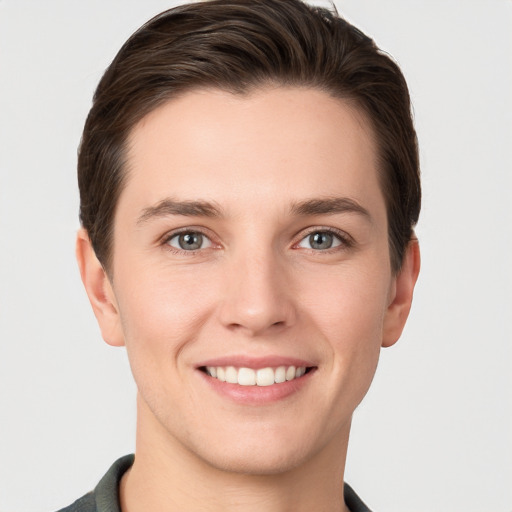 Joyful white young-adult female with short  brown hair and grey eyes