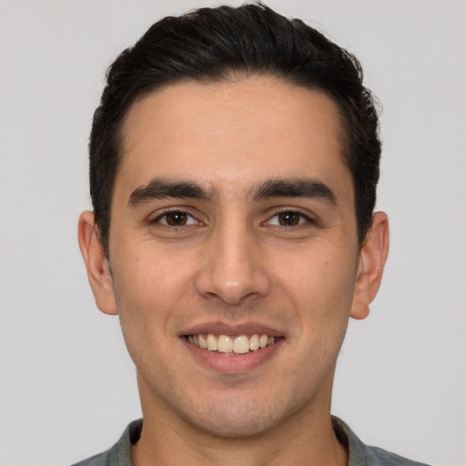 Joyful white young-adult male with short  brown hair and brown eyes