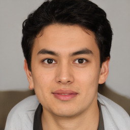 Joyful latino young-adult male with short  brown hair and brown eyes