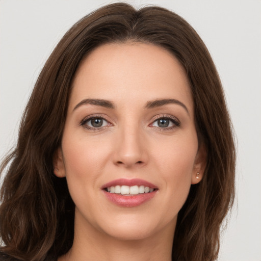 Joyful white young-adult female with long  brown hair and brown eyes