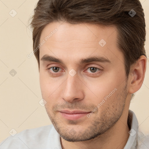 Joyful white young-adult male with short  brown hair and brown eyes