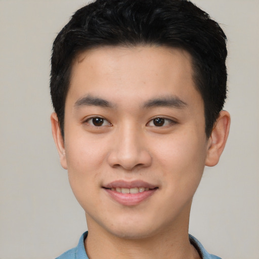 Joyful asian young-adult male with short  black hair and brown eyes