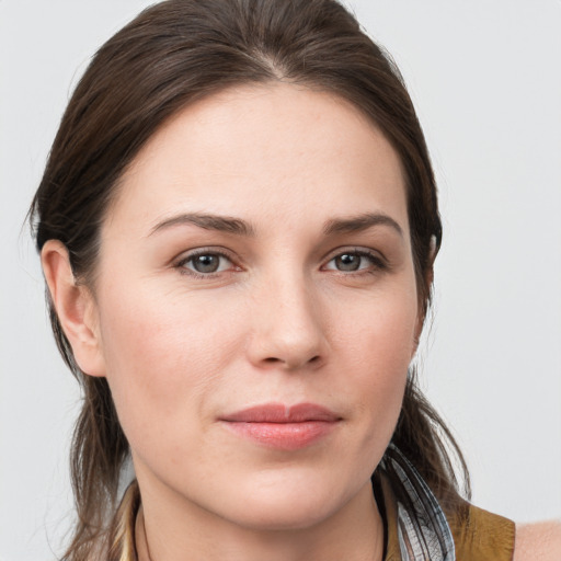 Joyful white young-adult female with medium  brown hair and grey eyes