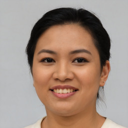 Joyful asian young-adult female with medium  brown hair and brown eyes