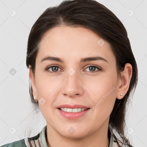 Joyful white young-adult female with medium  brown hair and grey eyes