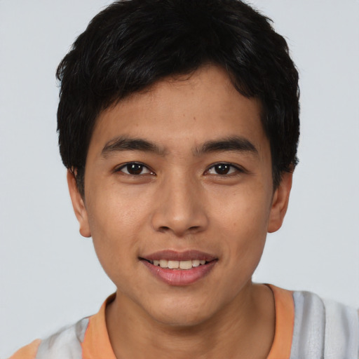 Joyful asian young-adult male with short  black hair and brown eyes