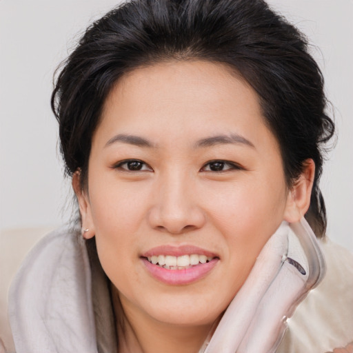Joyful asian young-adult female with medium  brown hair and brown eyes