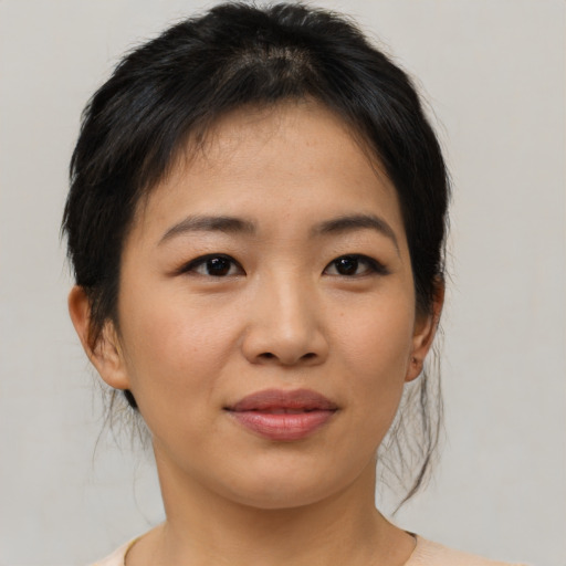 Joyful asian young-adult female with short  brown hair and brown eyes