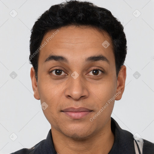 Joyful latino young-adult male with short  black hair and brown eyes
