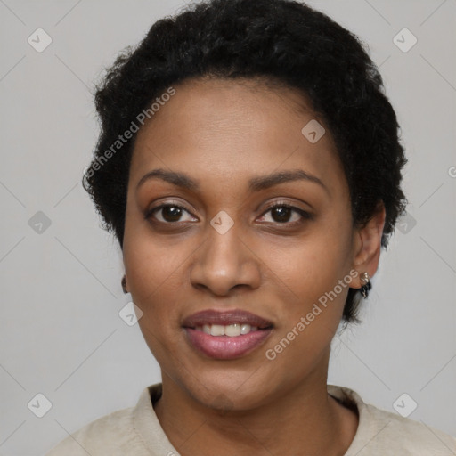 Joyful black young-adult female with short  black hair and brown eyes